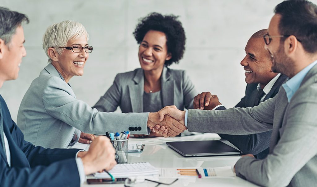 A group of people shaking hands in agreement